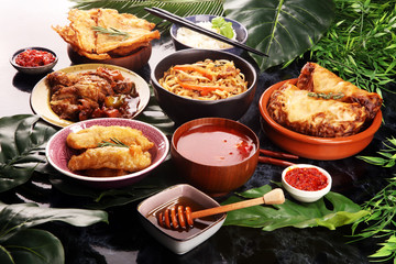 Assorted Chinese food set. Chinese noodles, fried rice, peking duck, dim sum, spring rolls. Famous Chinese cuisine dishes on table. Chinese restaurant concept. 