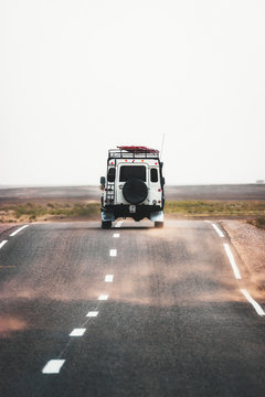On the road to Merzouga, car travels the road to the Sahara desert of Morocco during a sandstorm.