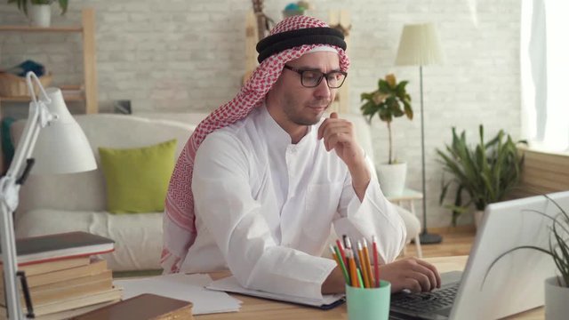 Arab man businessman at work at a laptop