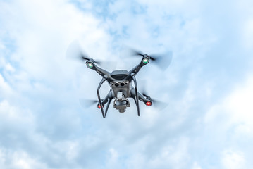 Drone in the sky. Unmanned aerial vehicle flying in the air.
