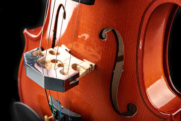 Beautiful new shiny violin on a dark table. Musical string instrument prepared for work. © Piotr