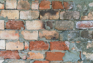 Background of old vintage dirty brick wall with peeling plaster, texture