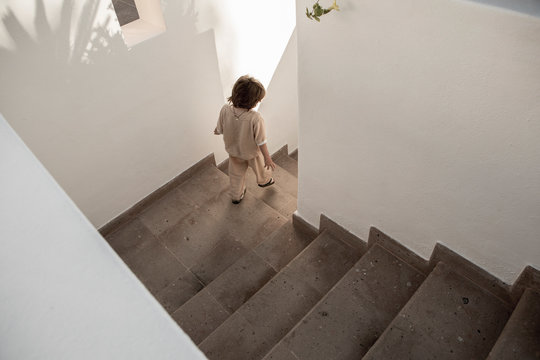 5 year old boy descending stairs, Todos Santos, Mexico