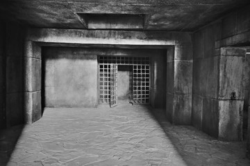 Fototapeta na wymiar The entrance to the dark dungeon with walls of large concrete blocks and a ceiling of monolithic reinforced concrete, made in the form of a steel lattice