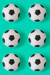 Naklejka premium Many black and white soccer balls background. Football balls in a water