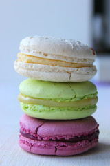 Colorful French or Italian macaroon stack cakes / Macaroon cakes. Assorted macaroon cakes stacked on top of each other on a light background. Copy space. Delicious dessert.