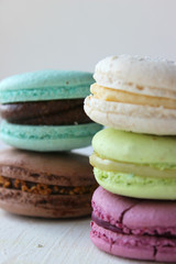 Colorful French or Italian macaroon stack cakes / Macaroon cakes. Assorted macaroon cakes stacked on top of each other on a light background. Copy space. Delicious dessert.