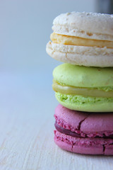 Colorful French or Italian macaroon stack cakes / Macaroon cakes. Assorted macaroon cakes stacked on top of each other on a light background. Copy space. Delicious dessert.