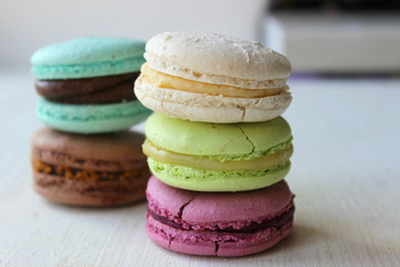 Colorful French or Italian macaroon stack cakes / Macaroon cakes. Assorted macaroon cakes stacked on top of each other on a light background. Copy space. Delicious dessert.