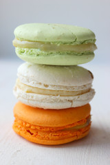Colorful French or Italian macaroon stack cakes / Macaroon cakes. Assorted macaroon cakes stacked on top of each other on a light background. Copy space. Delicious dessert.