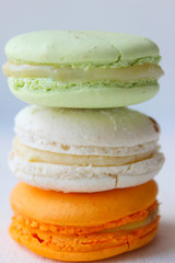 Colorful French or Italian macaroon stack cakes / Macaroon cakes. Assorted macaroon cakes stacked on top of each other on a light background. Copy space. Delicious dessert.