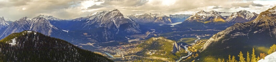 Wide Panoramic Landscape View of City of Banff in Bow Valley and Distant Snowcapped Mountain Peaks from Sulphur Mountain Gondola in Banff National Park, Canadian Rockies