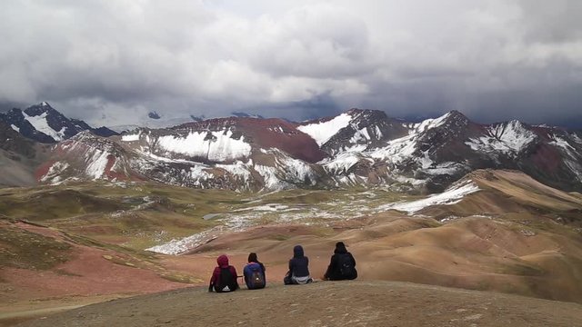 tourists and locals,panoramic view,Vinicunca, Seven Colors Mountain,Seven Colors Mountain,Trekking,Cusco, Per&uacute;.Tourists sitting on top of the mountain vinicunca (rainbow mountain) ,Peru