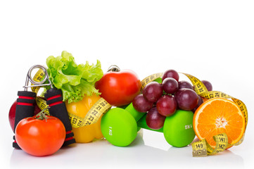 fitness equipment and healthy food isolated on white. apple, pepper, grapes, kiwi, orange, dumbbells and measuring tape.