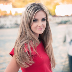 beautiful young girl, red dress, looks in the camera