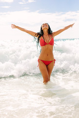 Woman enjoying her vacation on beach. - obrazy, fototapety, plakaty