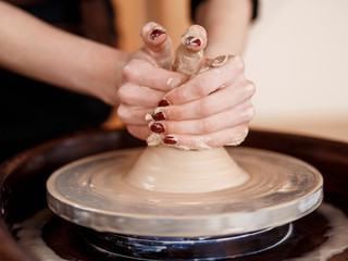 Hands sculpt new utensil on a pottery wheel
