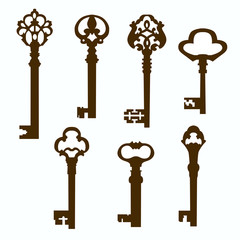 Many vintage keys silhouettes on white background