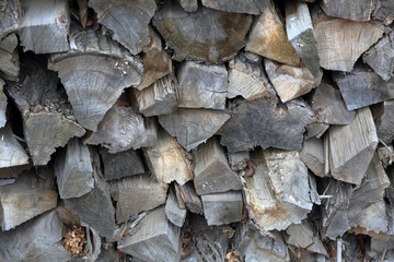 Dry firewood for firing and heating lie in a pile in the backyard