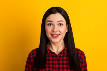 Portrait of an enthusiastic young girl screaming with joy over yellow background
