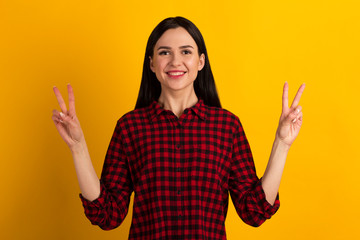 Close up photo beautiful amazed lady fingers show v-sign toothy beaming smiling pretty nice wearing casual red shirt isolated yellow bright background