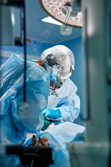 Team of surgeons makes an invasive operation. Portrait of surgeons close-up. Work with a...