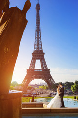 couple near Eiffel tower in Paris, romantic kiss