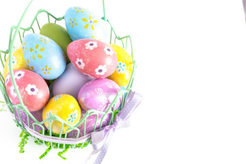 Easter Basket Filled with Decorated Eggs Isolated on a White Background