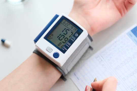 Hypertension. Patient measuring blood pressure.