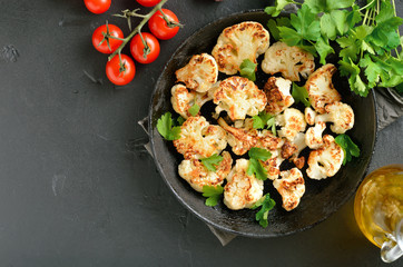 Fried cauliflower on plate,  fresh tomatoes and parsley