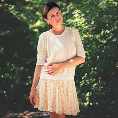 Fototapeta premium young woman among green trees