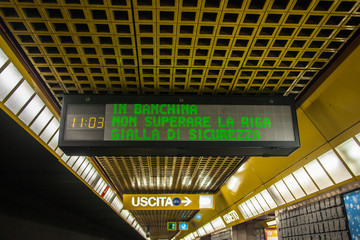electronic sign placed on the ceiling of the Milan subway