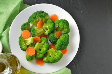 Broccoli and carrots on a white plate