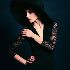 Woman in black dress and hat