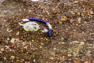 summer sea activity concept picture of snorkeling simple equipment mark and tube on stone beach...