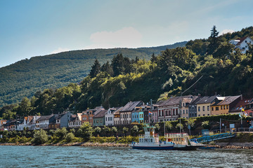 ferry floats on the river against the backdrop of the village