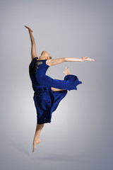 Young beautiful girl dancer performs a graceful jump. Movement. Flight, Grace