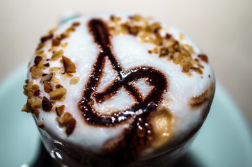 Cup of cappuccino photographed at close range to emphasize the design