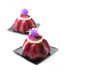 Dark red fruit desserts with edible purple pea flower