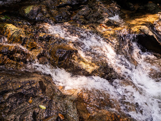 Water flows over the rocks of the waterfall on Koh Phangan. Thailand