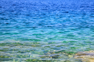Fototapeta na wymiar Sea surface in vibrant blue, green and turquoise hues. 
