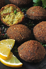Fresh falafel balls, spices, sauce and herbs. Vegan falafel. Healthy lean food. Middle Eastern cuisine.
