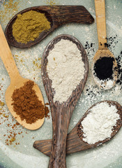 Various kinds of powders on wooden spoons