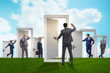 Fototapeta premium Businessman in uncertainty concept with many doors