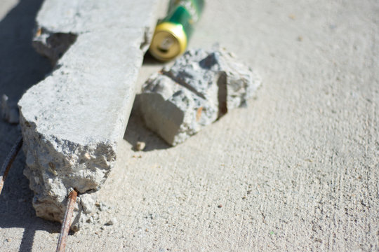 Can And Concrete Debris And Litter In Storm Drain At Park