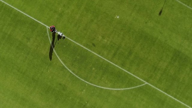 Top view of Marking football stadium field using a professional paint machine
