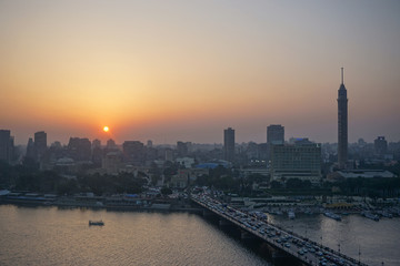 Cairo, Egypt: Cairo Tower and the Qasr el Nile Bridge at sunset. On Gezira Island in the River Nile, the tower is the tallest structure in Egypt. © Linda Harms