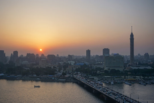 Cairo, Egypt: Cairo Tower and the Qasr el Nile Bridge at sunset. On Gezira Island in the River Nile, the tower is the tallest structure in Egypt.