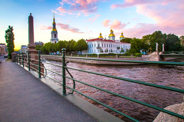 St. Petersburg. Russia. Panorama of St. Petersburg. View of the Nicholas Naval Cathedral through the Kryukov Canal. Summer sunset.. Petersburg landmarks. Russian cities. Architecture of  Petersburg.