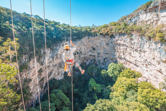 Woman rappelling at the amazing Sima de las Cotorras sinkhole, located in Chiapas Mexico